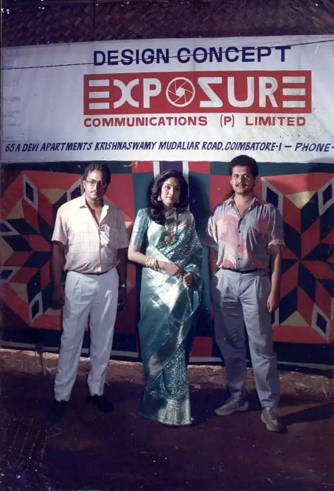 Mr. Ismail with a guest at the Exposure Communications studio banner