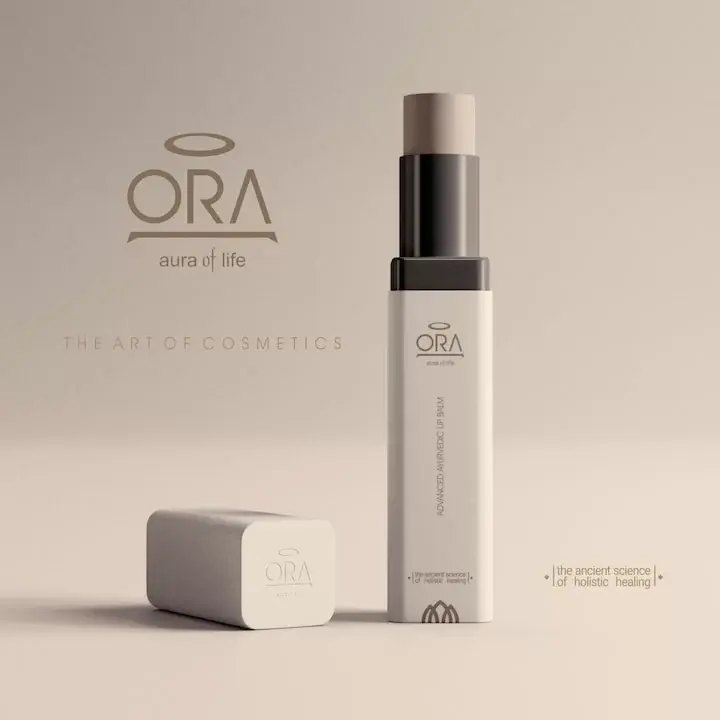ORA - aura of life: Advanced Ayurvedic Lip Balm in matte white packaging on warm grey background