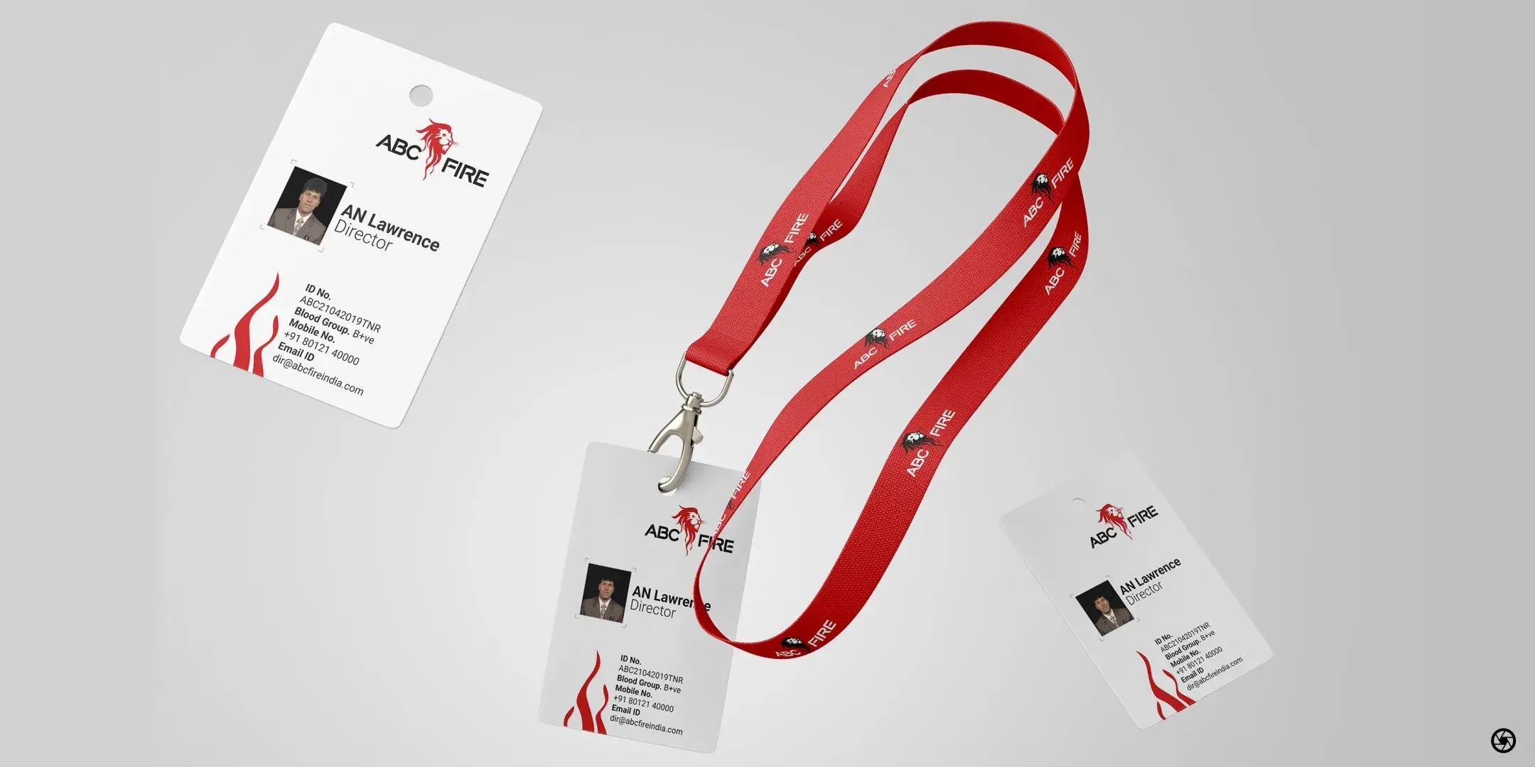 ABC Fire - staff ID card held on a red branded lanyard, the lanyard printed with a repeat of the lion-and-wordmark