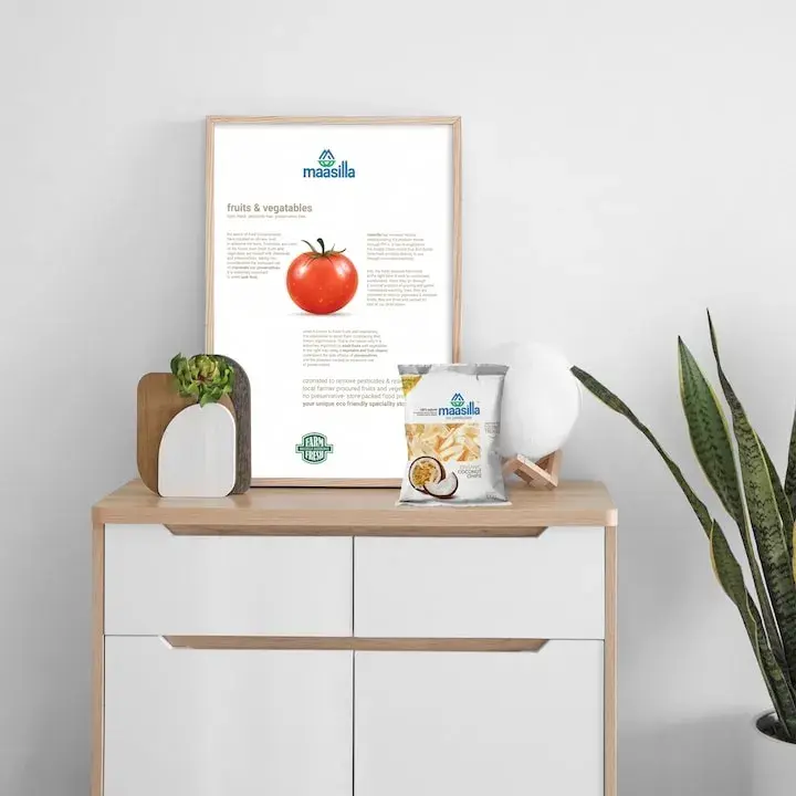 Maasilla poster displayed with coconut chips pack - print and packaging coherence across the same brand voice