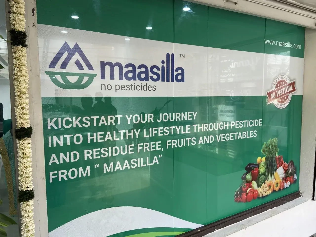 Maasilla storefront window decal in English - 'Kickstart your journey into healthy lifestyle through pesticide and residue free fruits and vegetables'