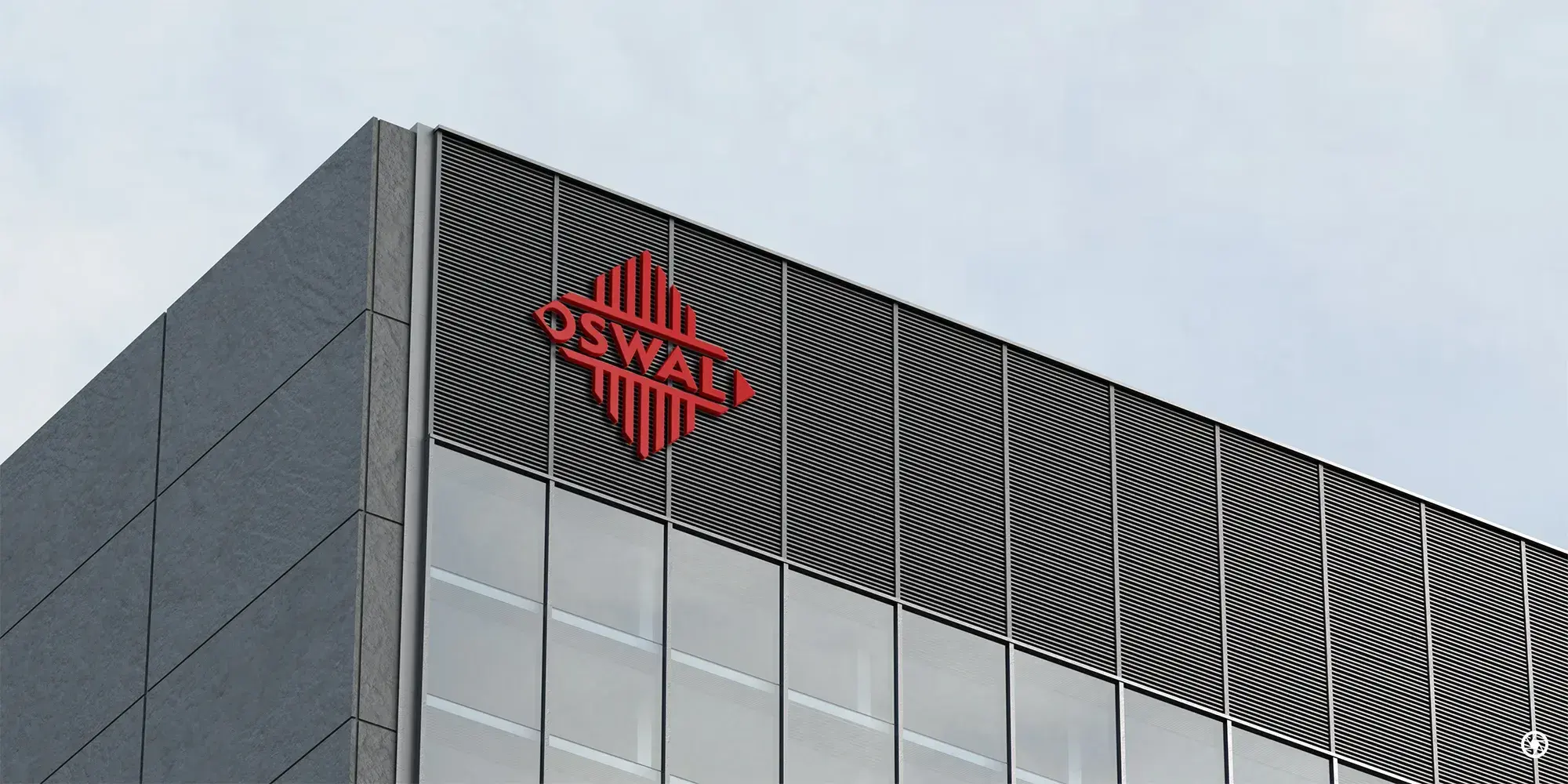 Oswal Granites & Tiles - red diamond mark signage on a commercial building facade