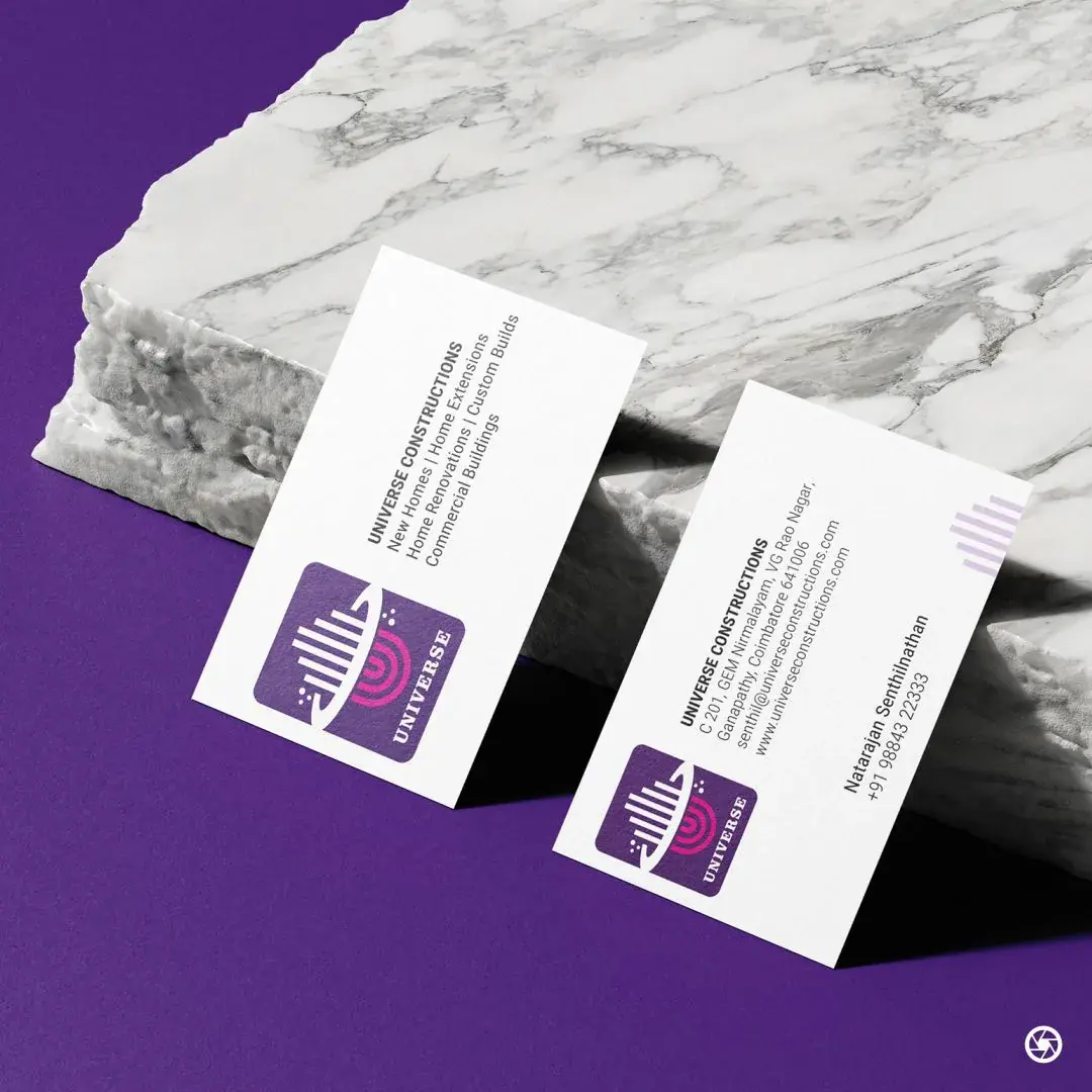 Universe Constructions - business card front and reverse on a marble slab, the mark and wordmark set in purple and magenta