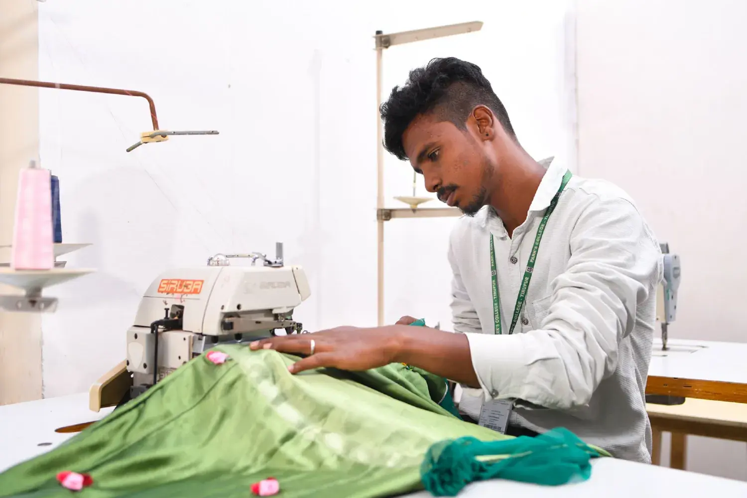 A Park's College student at the sewing and textile workstation